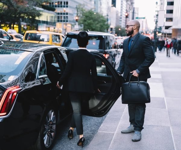 successful-business-partners-getting-in-car-at-cit-2024-05-28-17-44-19-utc-1-2-3